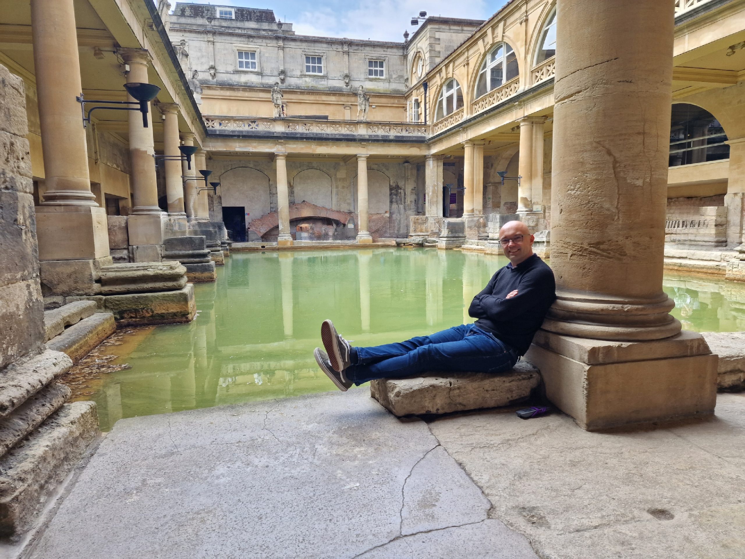 Picture of a guide sitting at the Roman baths, in Bath, UK